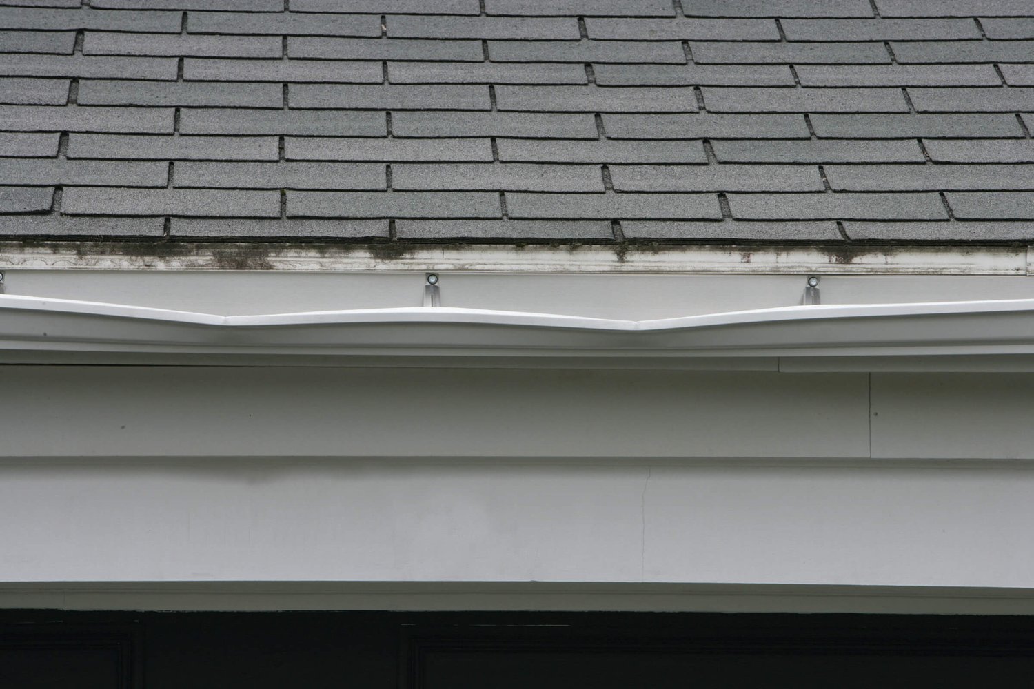 Collapsed gutter on a grey roof